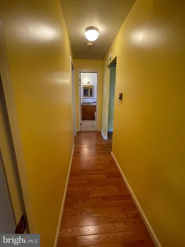 a view of hallway with wooden floor