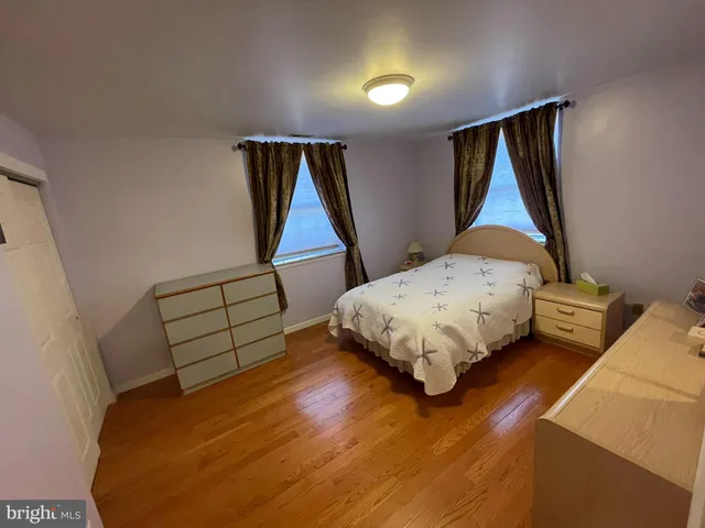 a bedroom with bed and a window