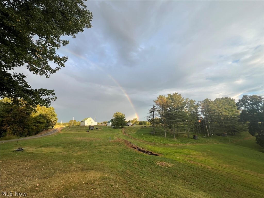 1105 Dutch Ridge Road Guysville, OH 45735 - Photo 28 of 33 Expansive green landscape featuring mature trees and distant structures
