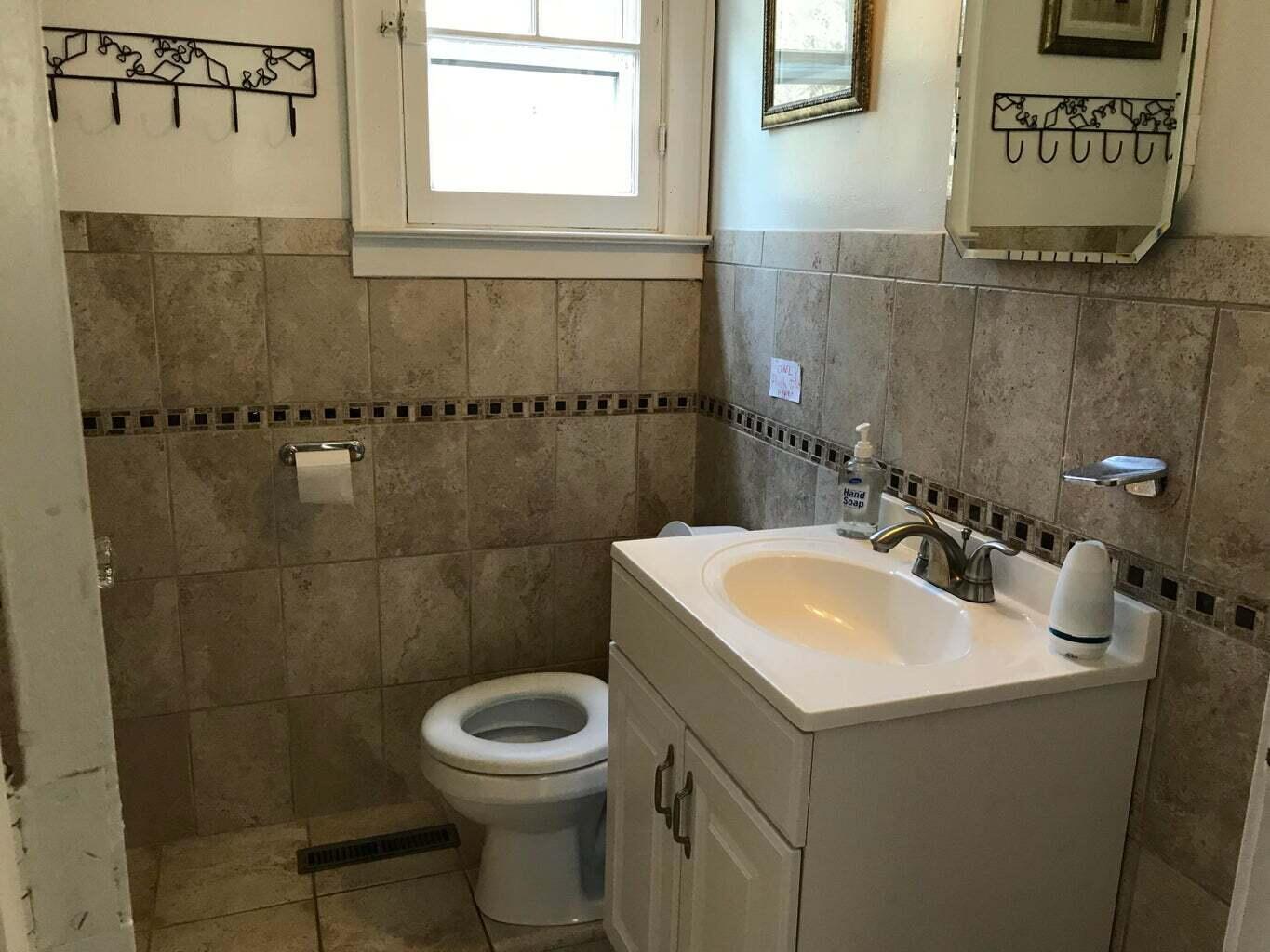 605 Cable Road Eastham, MA 02642 - Photo 12 of 25 a bathroom with a sink a toilet and a mirror