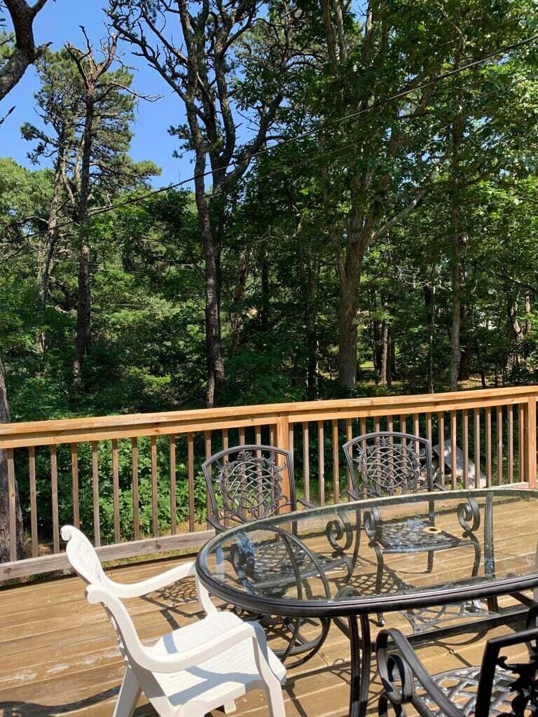 605 Cable Road Eastham, MA 02642 - Photo 16 of 25 a view of a patio with a table and chairs