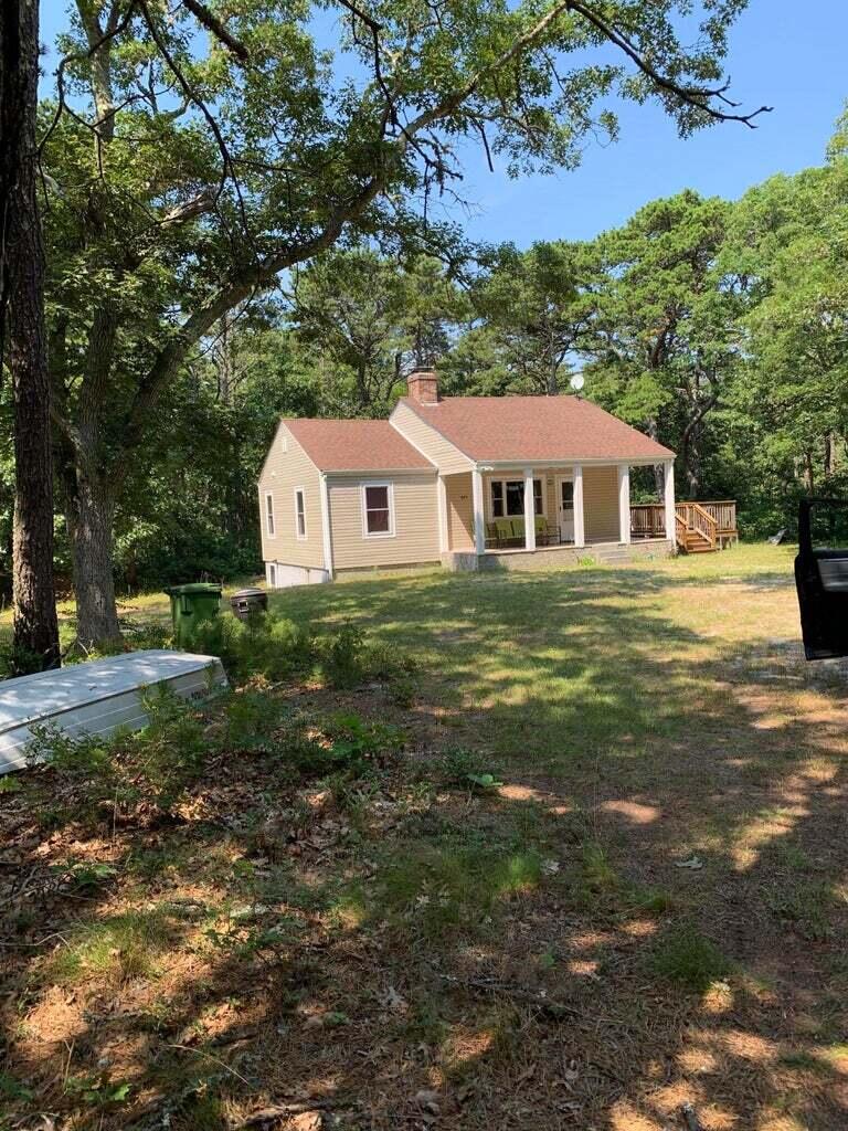 605 Cable Road Eastham, MA 02642 - Photo 2 of 25 a view of a house with a yard