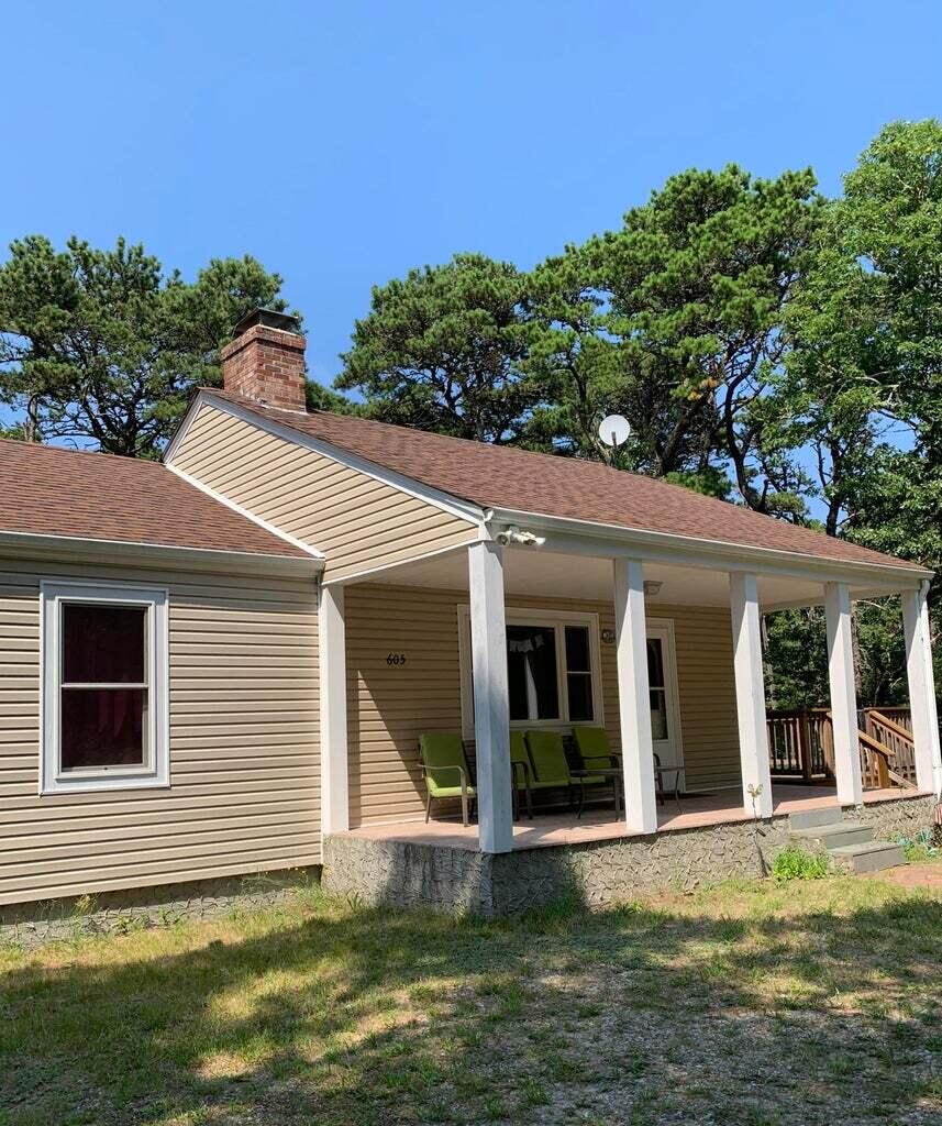 605 Cable Road Eastham, MA 02642 - Photo 5 of 25 a front view of a house with a yard
