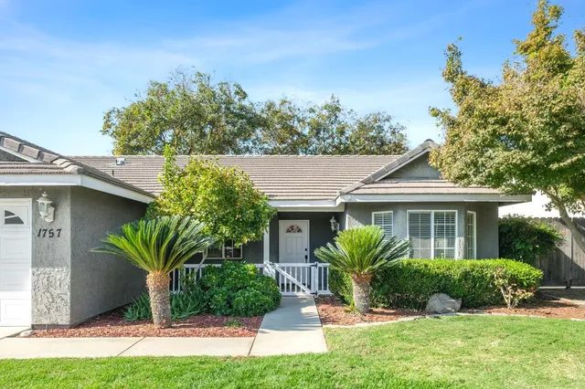 a view of a house with a yard and plants