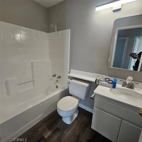 a white toilet sitting next to a bath tub
