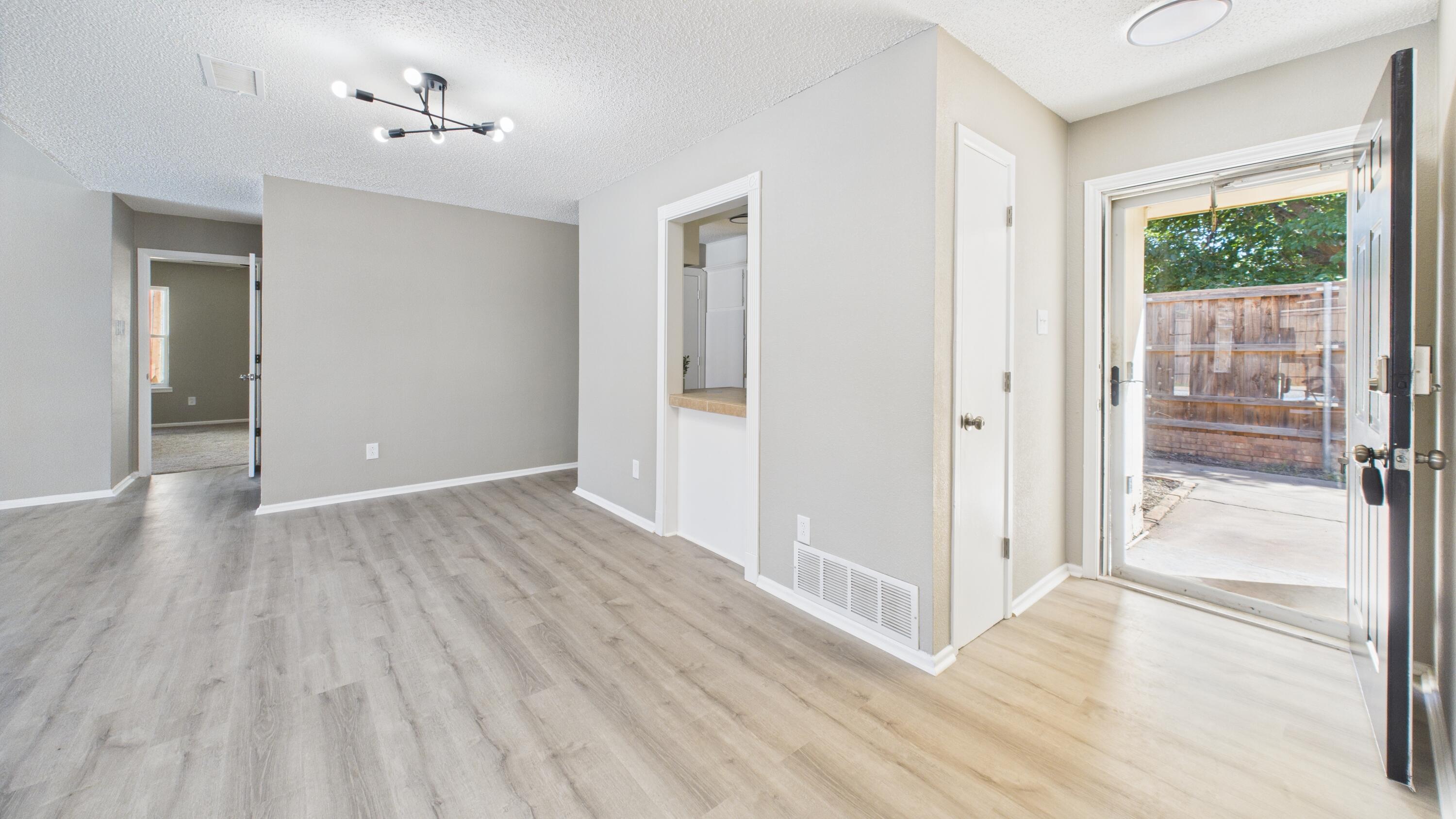 5719 2nd Street Lubbock, TX 79416 - Photo 17 of 61 a view of a hallway with wooden floor and a bathroom