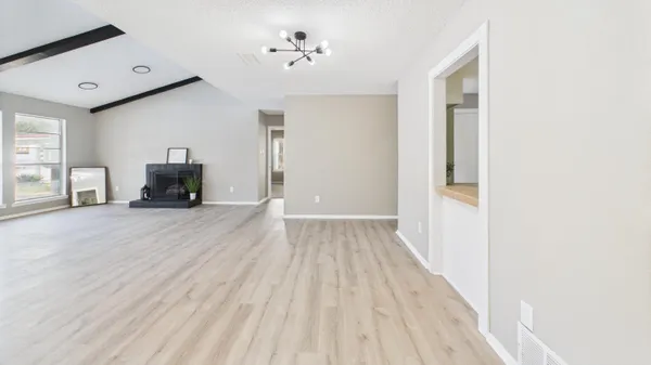 a view of a livingroom with wooden floor and a fireplace