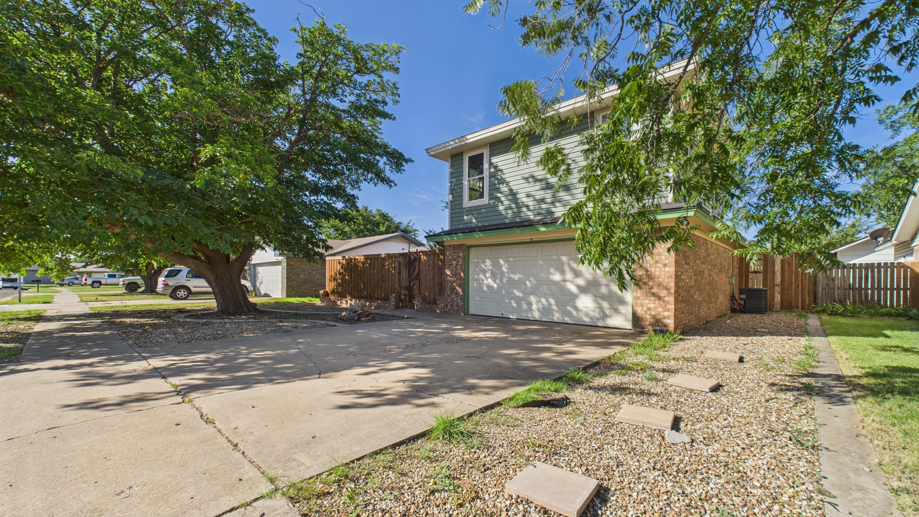 5719 2nd Street Lubbock, TX 79416 - Photo 2 of 61 a view of a yard with a tree in the house