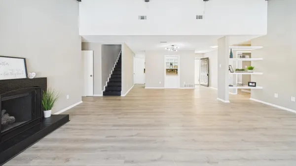 a large kitchen with stainless steel appliances granite countertop a lot of counter space and wooden floors