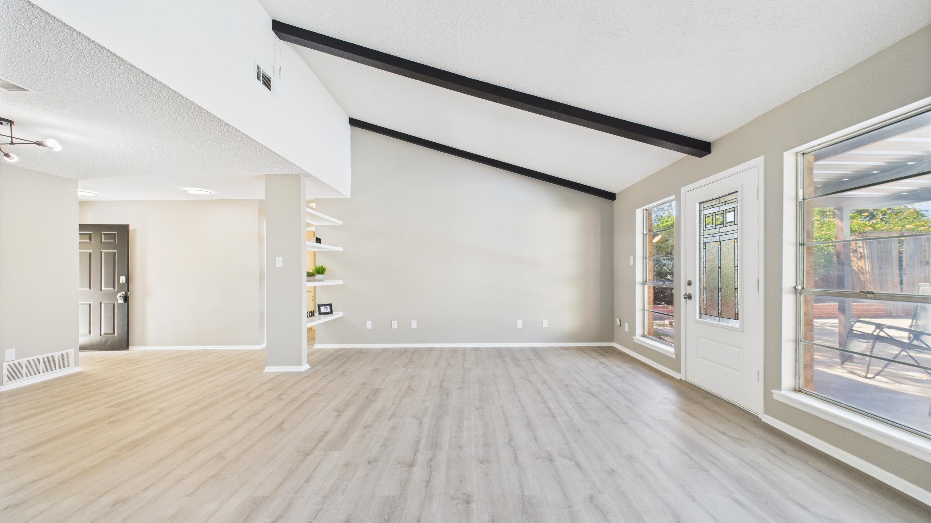 5719 2nd Street Lubbock, TX 79416 - Photo 24 of 61 a view of an empty room with wooden floor and a window