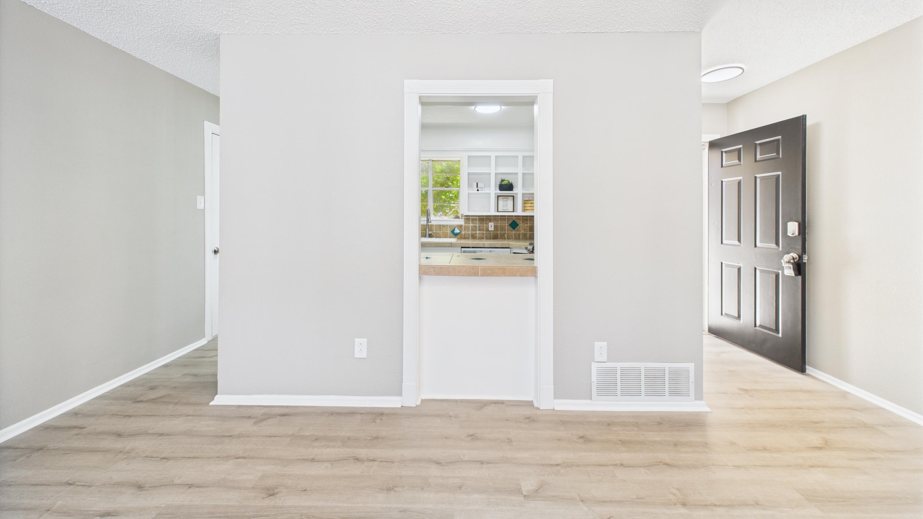 5719 2nd Street Lubbock, TX 79416 - Photo 25 of 61 a view of a hallway with wooden floor and a living room