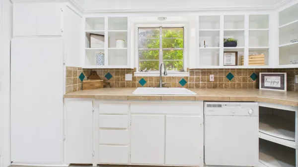 a bathroom with a sink a toilet and shower curtain