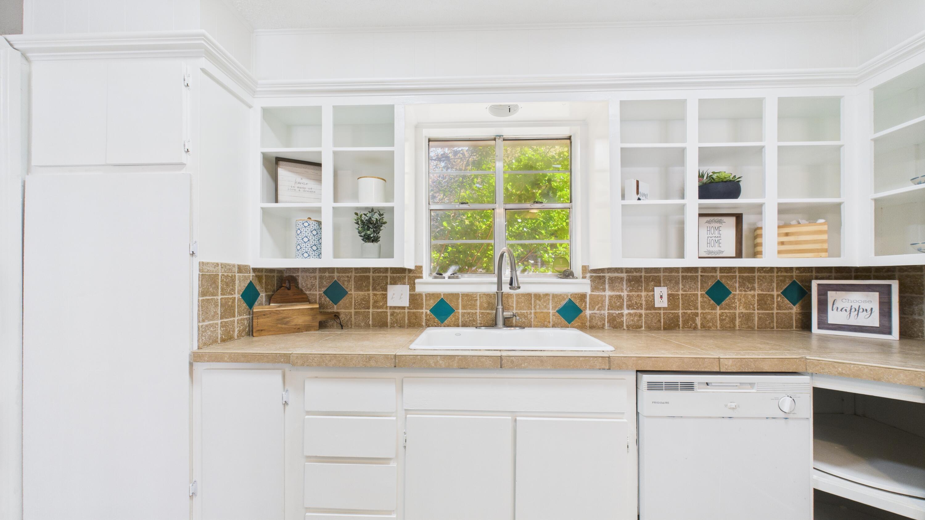 5719 2nd Street Lubbock, TX 79416 - Photo 29 of 61 a kitchen with granite countertop a sink and a window