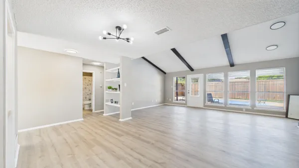 a view of empty room with ceiling fan