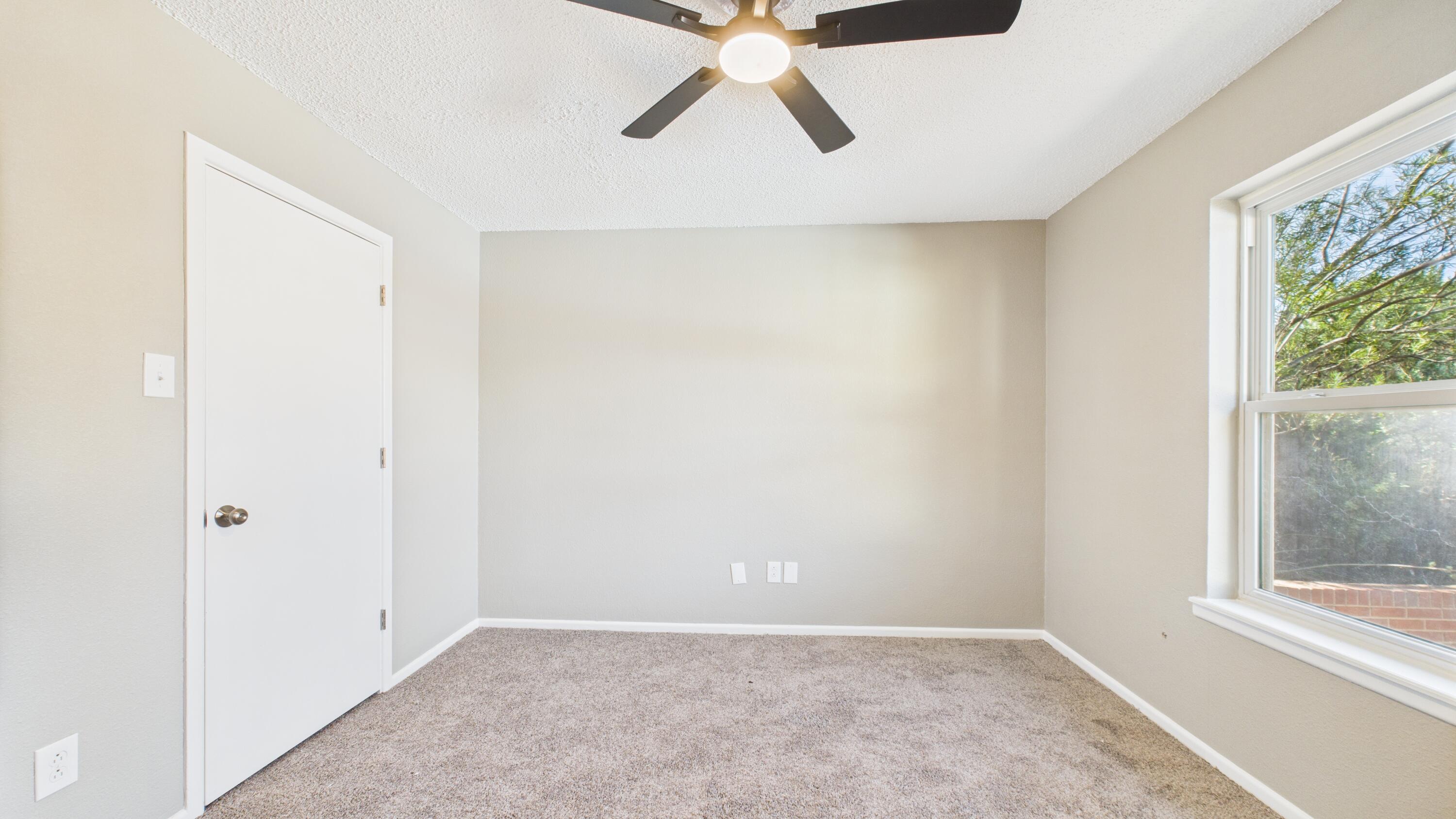 5719 2nd Street Lubbock, TX 79416 - Photo 38 of 61 an empty room with a window and a ceiling fan