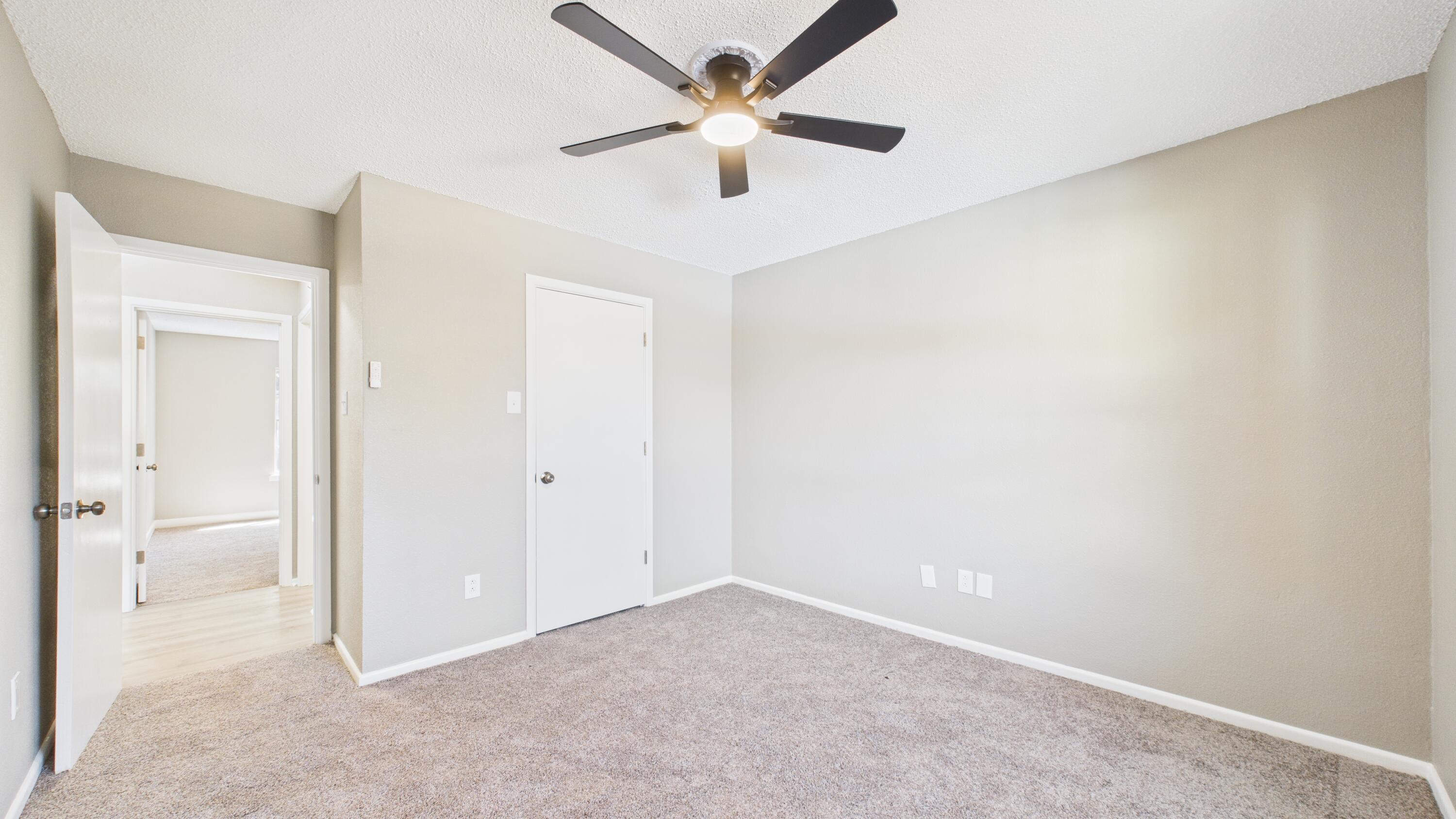 5719 2nd Street Lubbock, TX 79416 - Photo 39 of 61 a view of an empty room and a ceiling fan