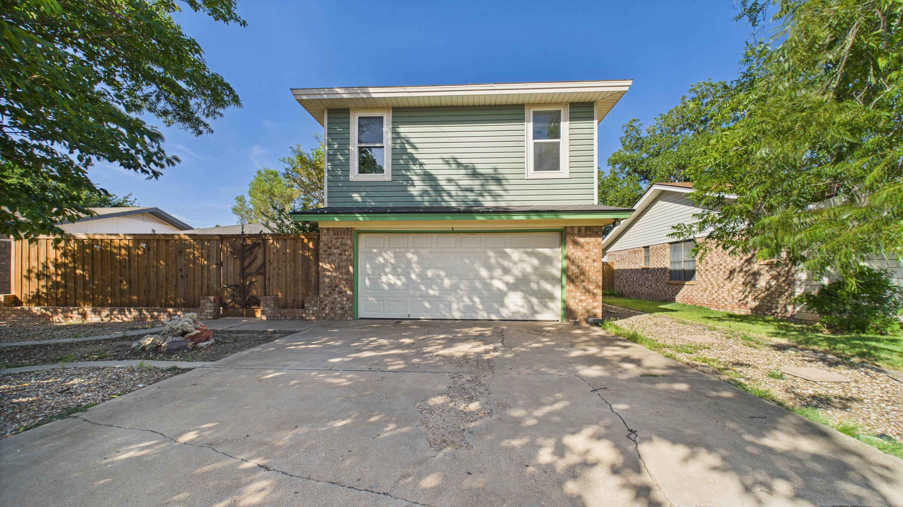 5719 2nd Street Lubbock, TX 79416 - Photo 4 of 61 a front view of a house with a yard and garage