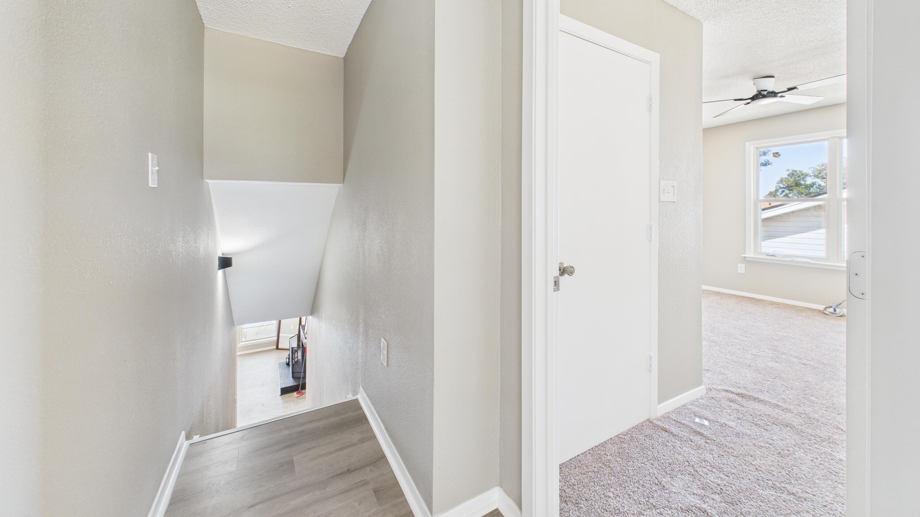 5719 2nd Street Lubbock, TX 79416 - Photo 50 of 61 a view of a hallway with wooden floor and closet