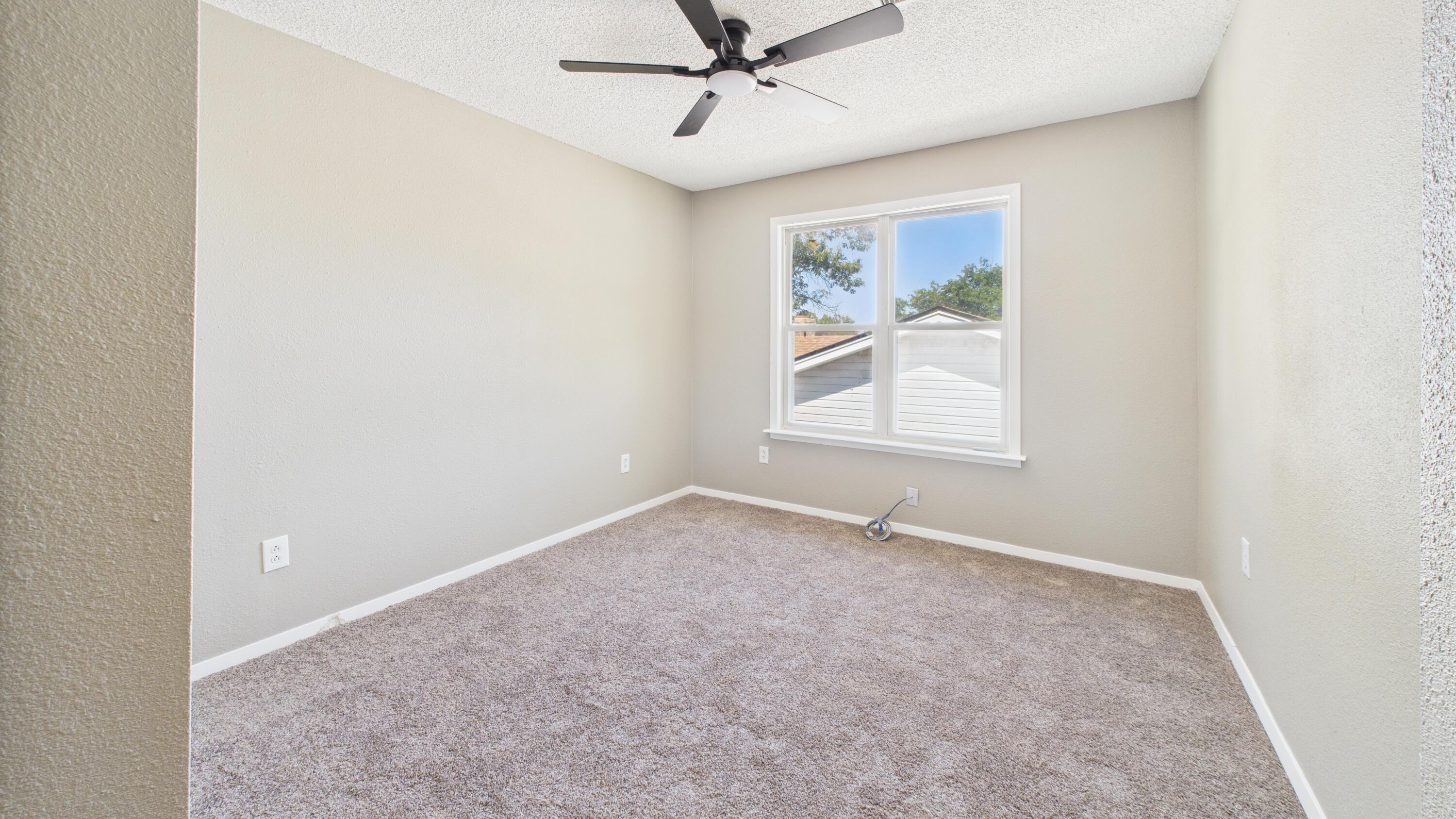 5719 2nd Street Lubbock, TX 79416 - Photo 53 of 61 an empty room with windows and fan