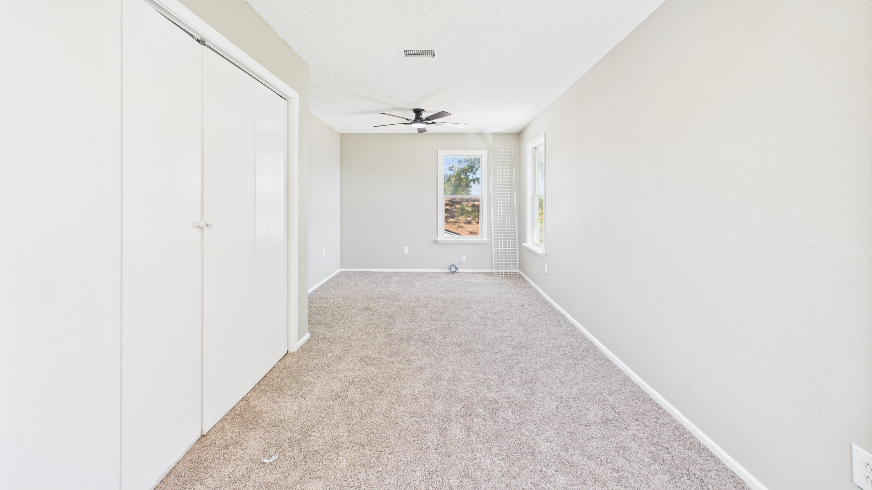 5719 2nd Street Lubbock, TX 79416 - Photo 54 of 61 an empty room with windows and chandelier