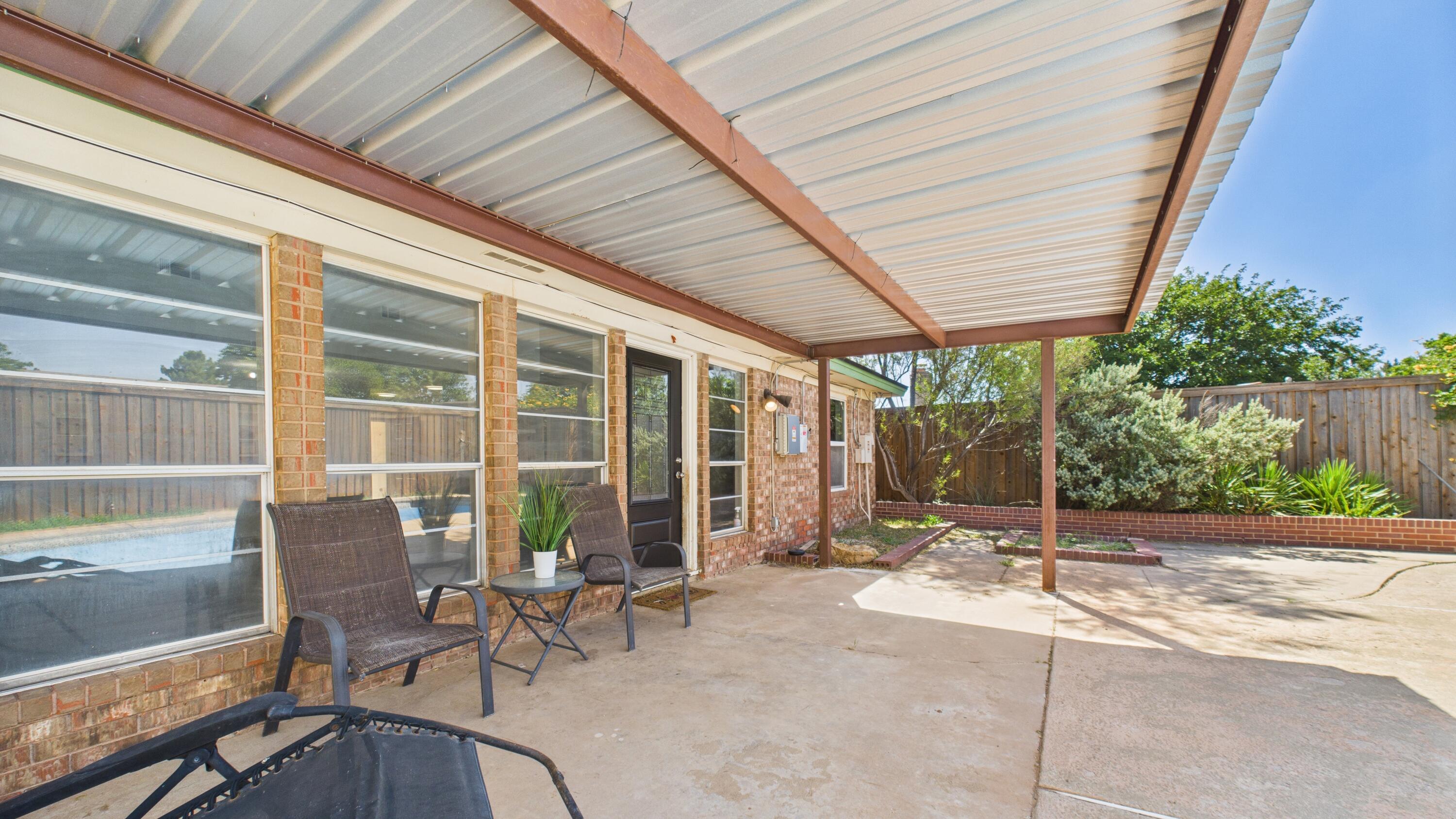 5719 2nd Street Lubbock, TX 79416 - Photo 58 of 61 a building outdoor space with patio furniture and potted plants