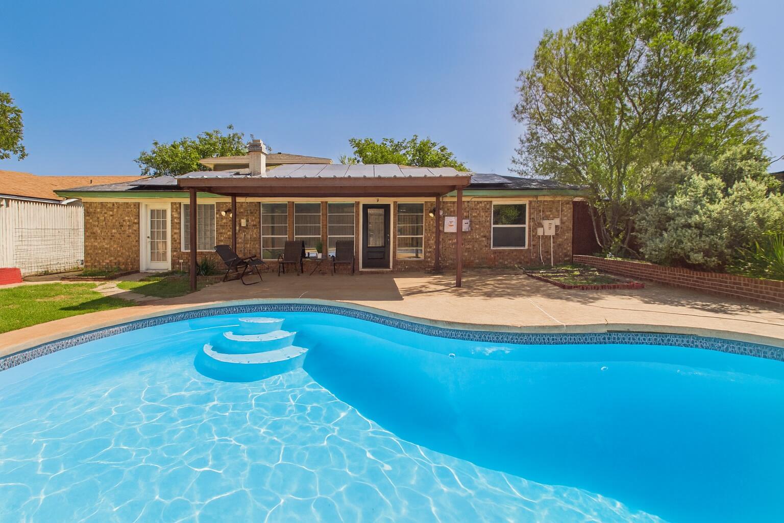 5719 2nd Street Lubbock, TX 79416 - Photo 60 of 61 a view of a house with swimming pool and a yard