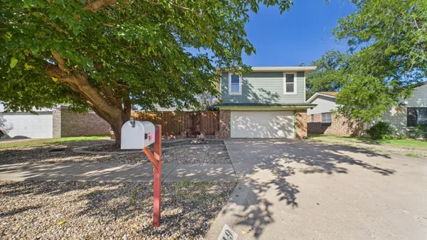 a view of a backyard with a tree