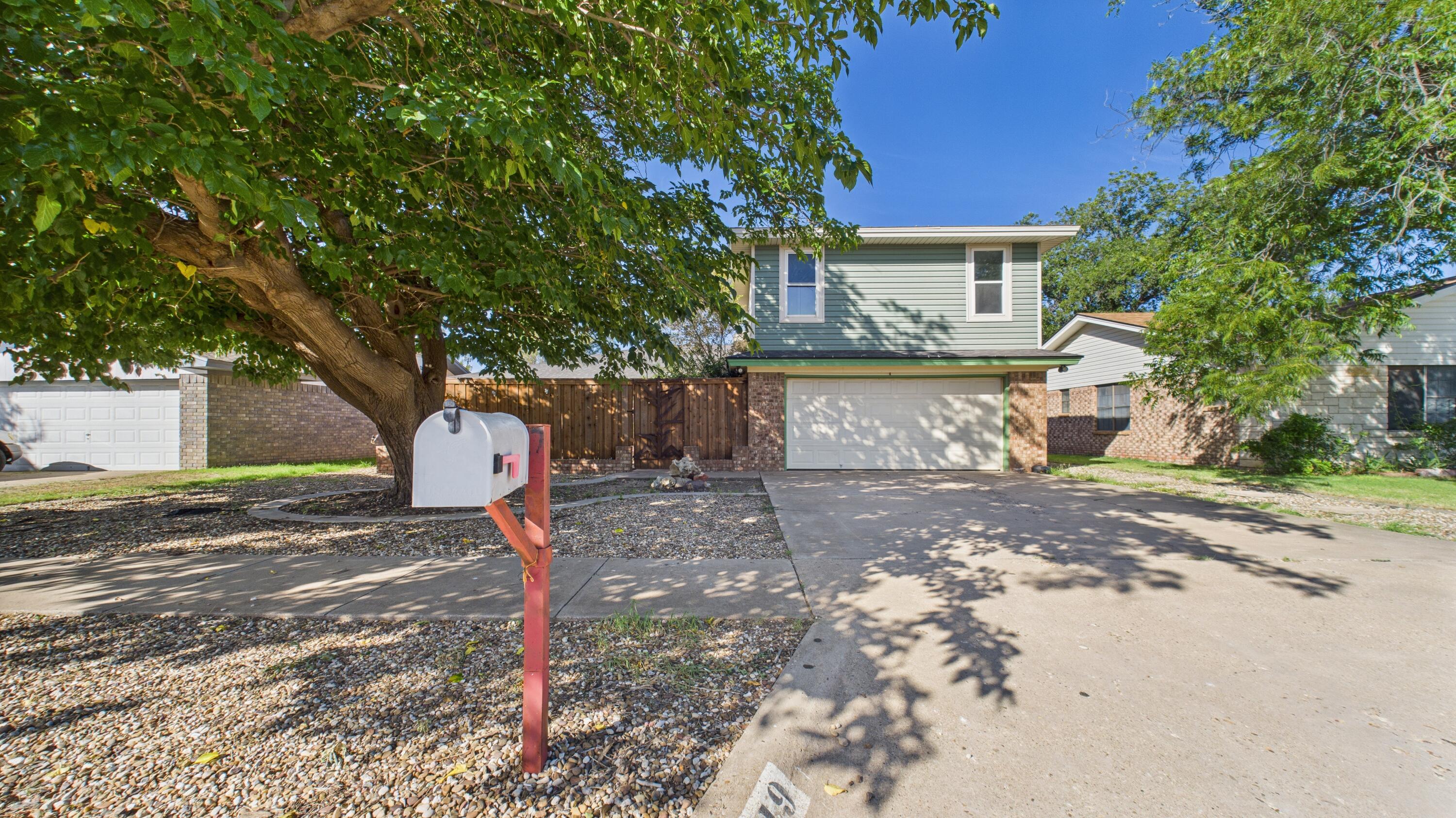 5719 2nd Street Lubbock, TX 79416 - Photo 7 of 61 a front view of a house with a yard and garage