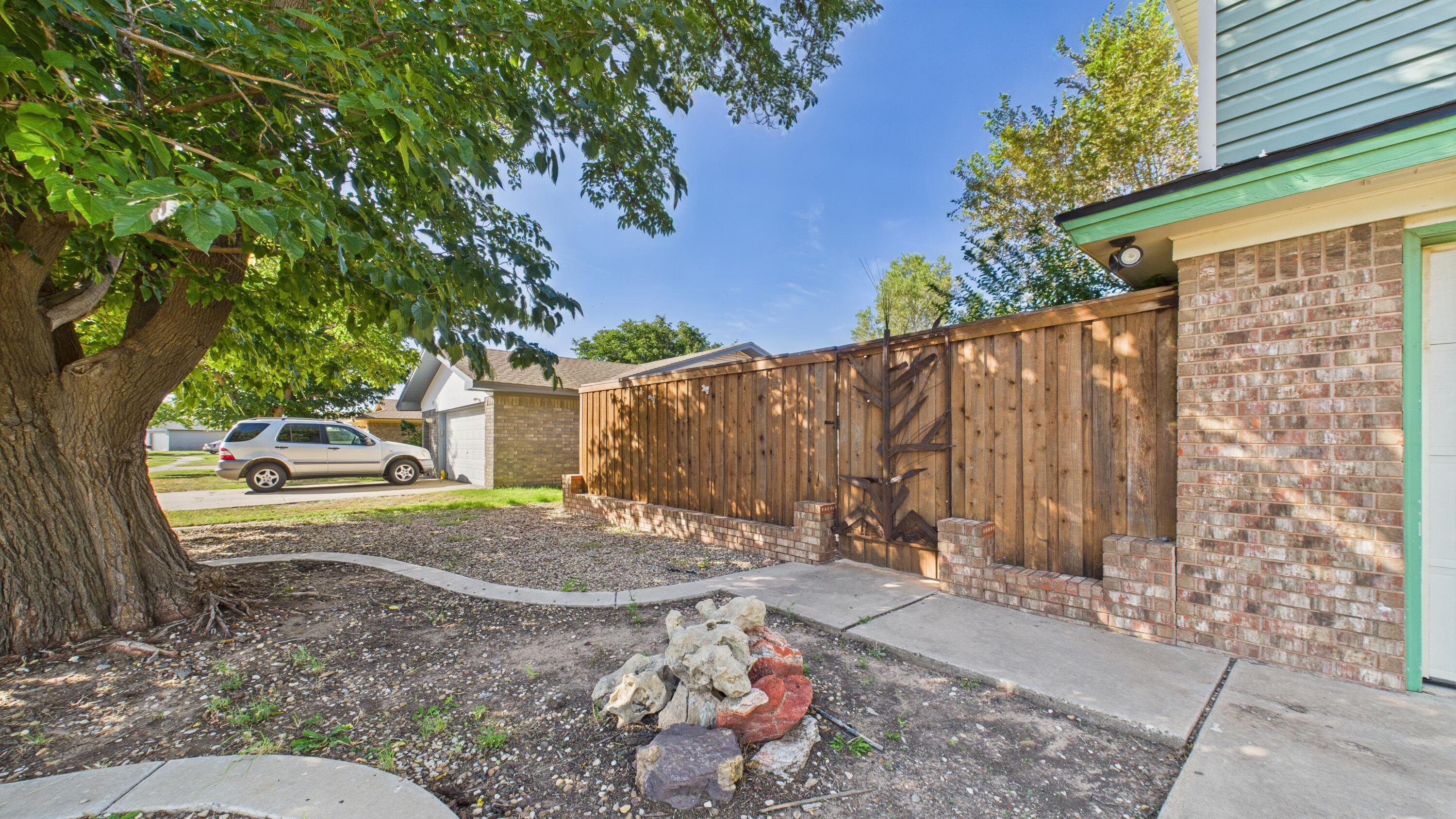 5719 2nd Street Lubbock, TX 79416 - Photo 8 of 61 a view of a backyard with a tree