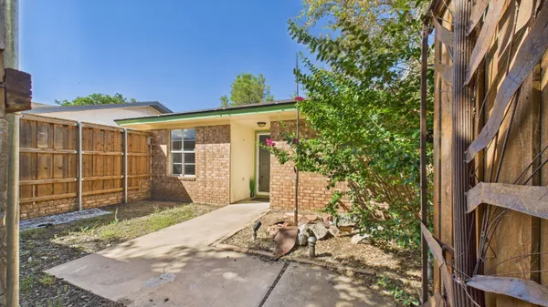 a backyard of a house with a tree