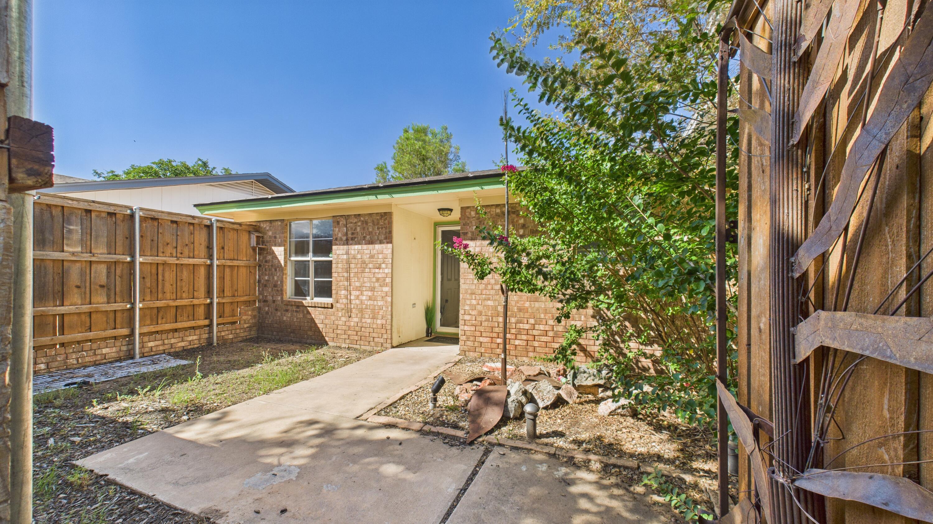 5719 2nd Street Lubbock, TX 79416 - Photo 9 of 61 a front view of a house with a yard and garage