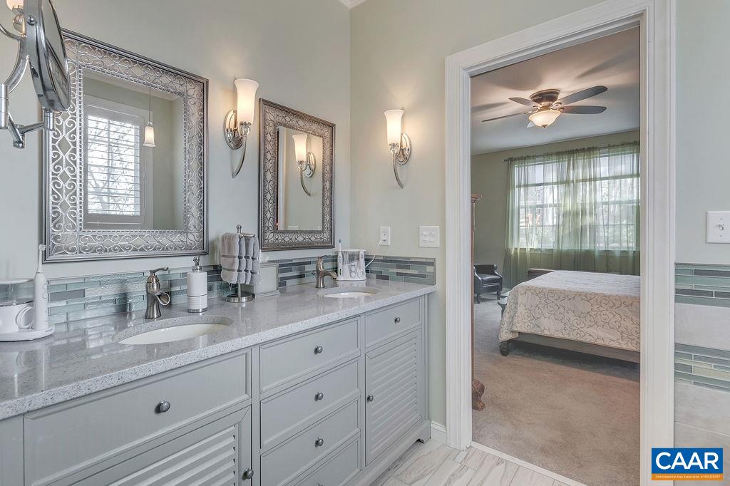 35 Oak Grove Road Palmyra, VA 22963 - Photo 12 of 42 a en suite bathroom with double vanity a mirror and a shower