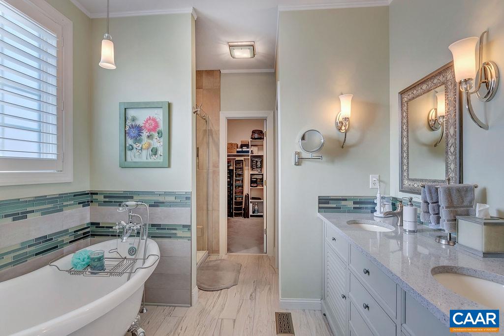 35 Oak Grove Road Palmyra, VA 22963 - Photo 13 of 42 a bathroom with a granite countertop tub sink and mirror