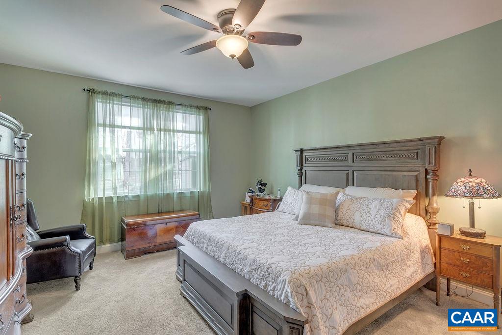 35 Oak Grove Road Palmyra, VA 22963 - Photo 16 of 42 a bedroom with a bed and a chandelier