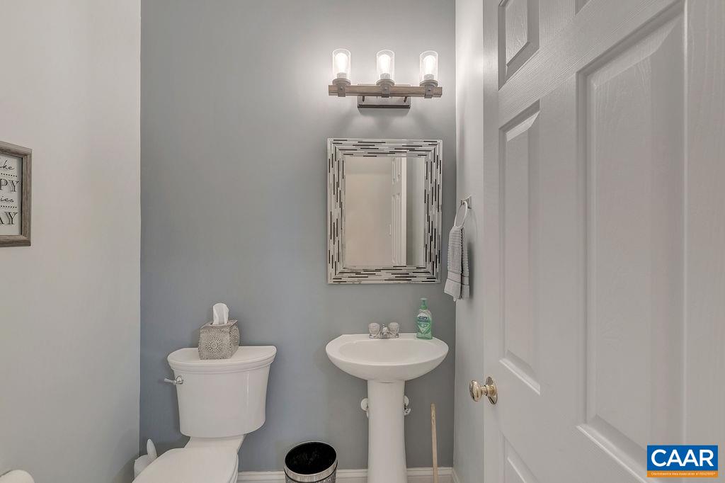 35 Oak Grove Road Palmyra, VA 22963 - Photo 23 of 42 a bathroom with a sink and mirror with toilet