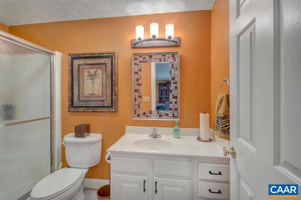 35 Oak Grove Road Palmyra, VA 22963 - Photo 28 of 42 a bathroom with a granite countertop toilet sink and mirror