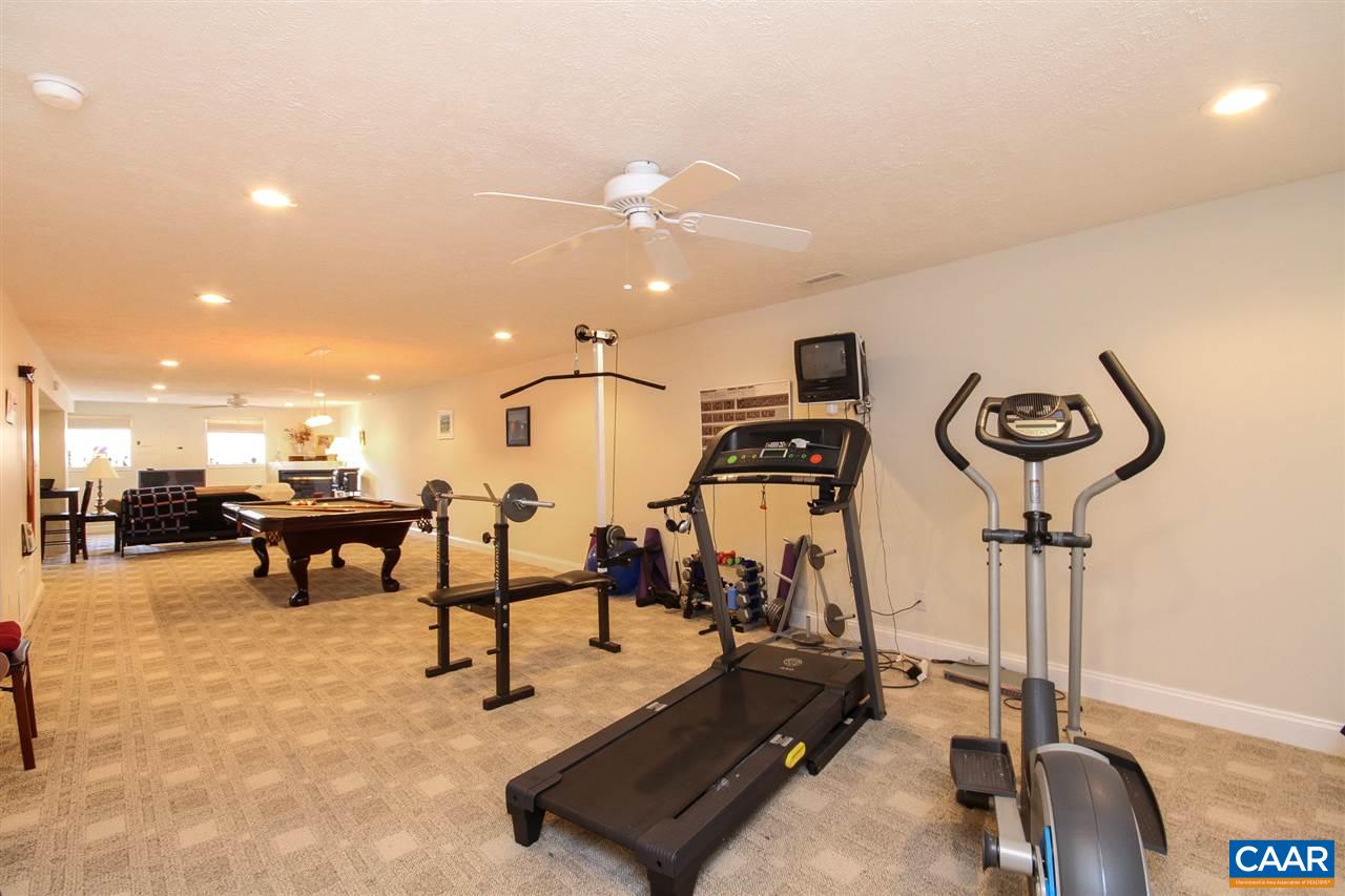 35 Oak Grove Road Palmyra, VA 22963 - Photo 30 of 42 a room with gym equipment and a chandelier