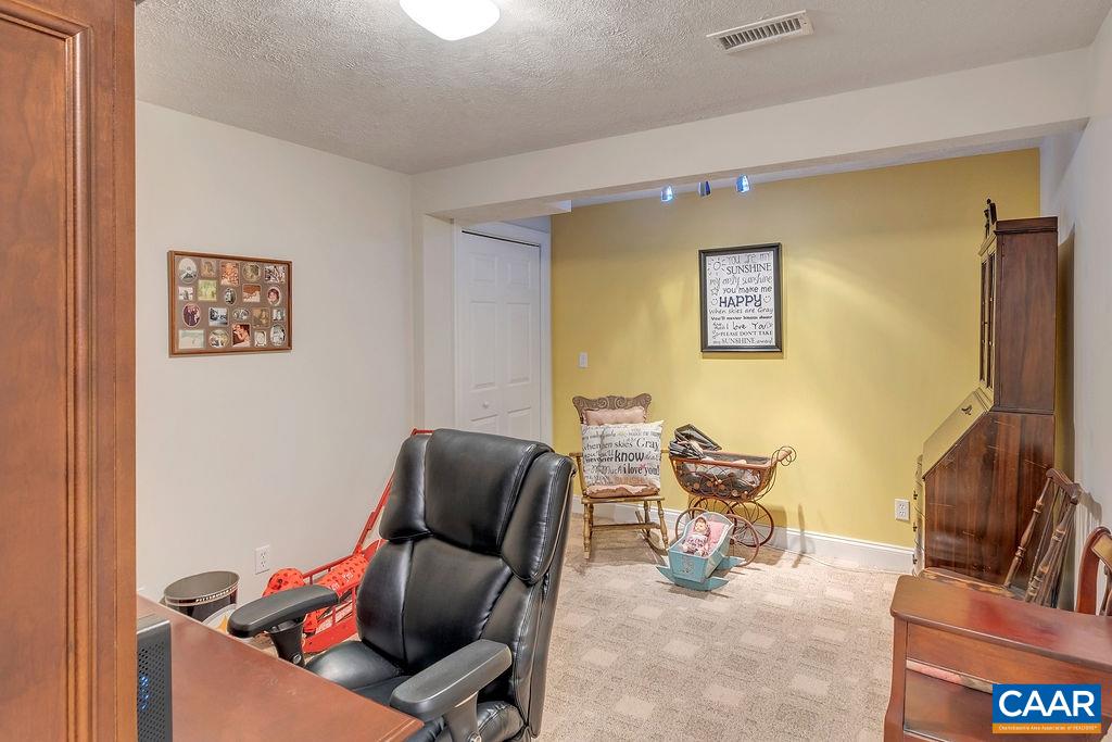 35 Oak Grove Road Palmyra, VA 22963 - Photo 35 of 42 a living room with furniture and a flat screen tv