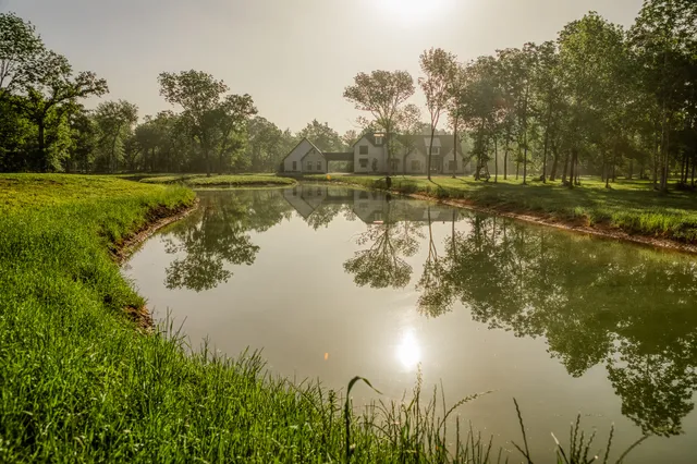 a view of a lake with a yard and trees