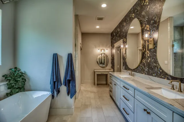 a bathroom with a double vanity sink a mirror and a bathtub