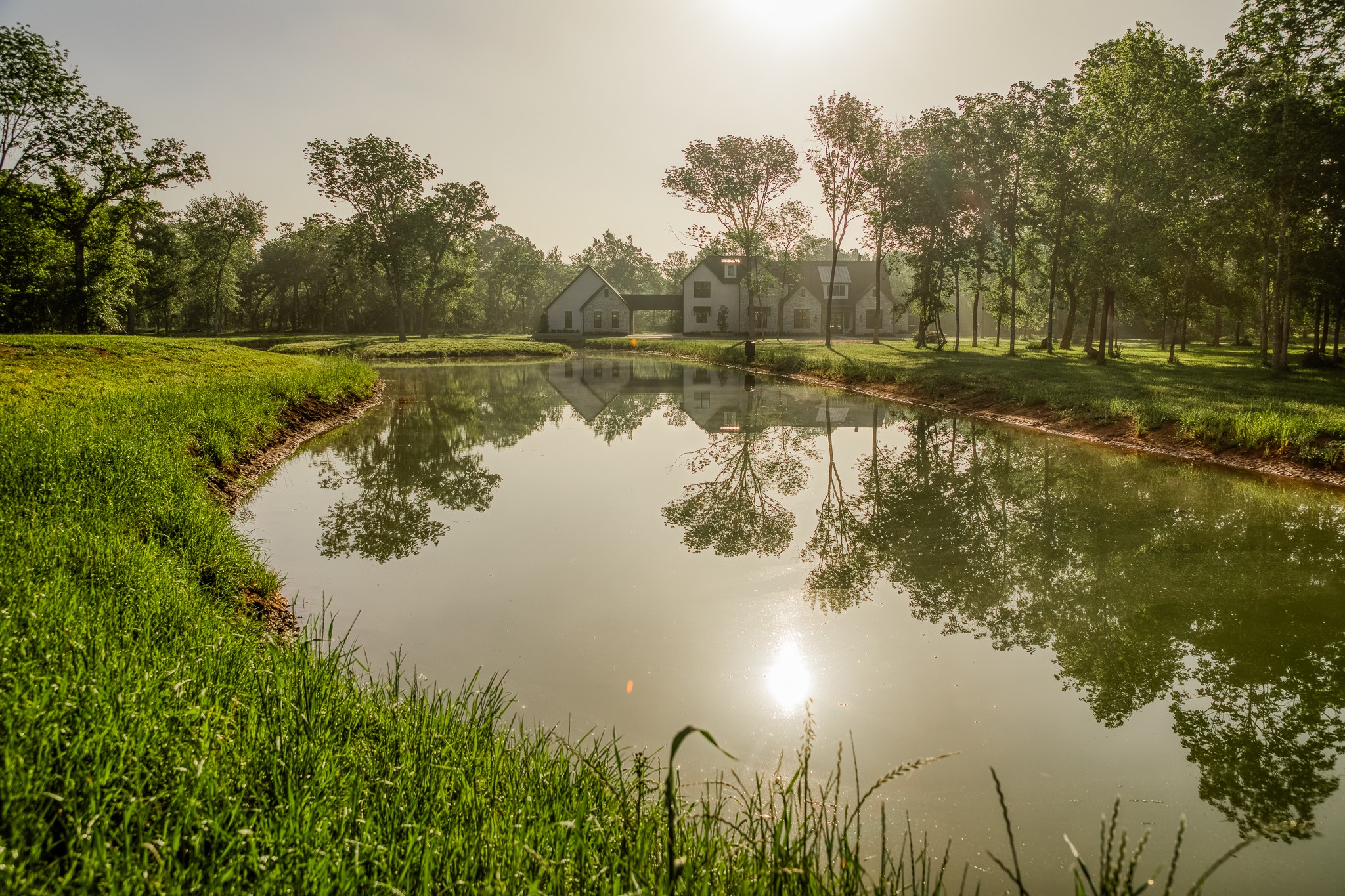 40051 Mesquite Hempstead, TX 77445 - Photo 2 of 29 a view of a lake with a yard and trees