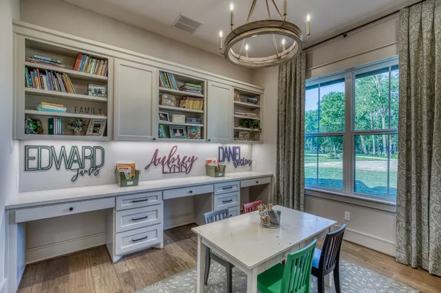 a kitchen with a table chairs and cabinets