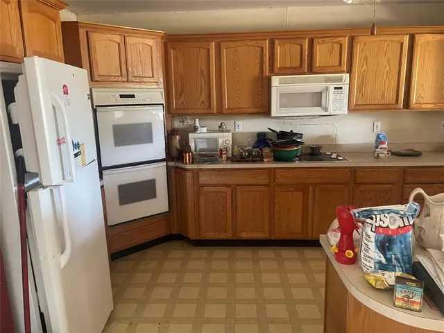 a kitchen with stainless steel appliances a stove a refrigerator and cabinets