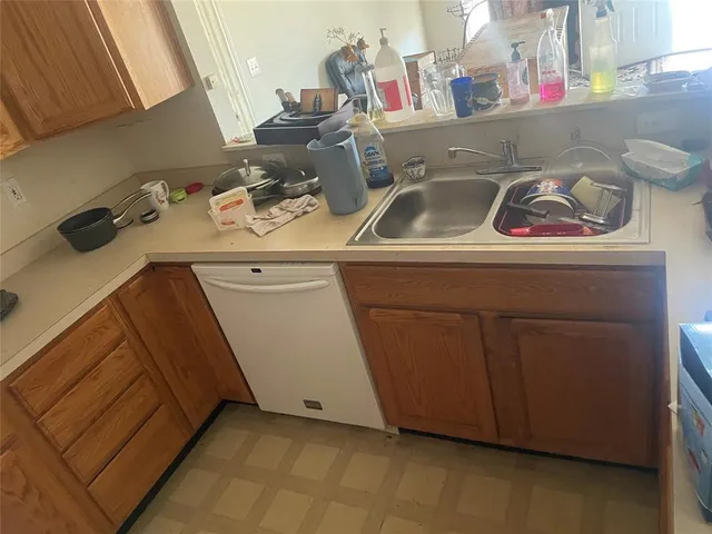 a utility room with sink dryer and washer