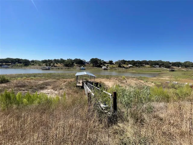 a view of a lake with houses in the back