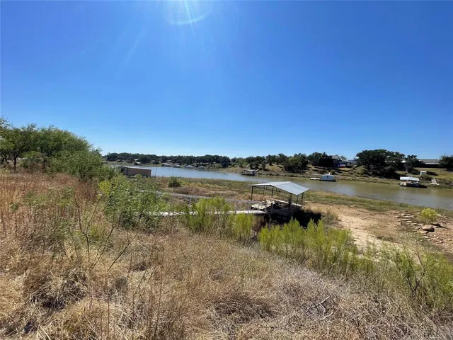 a view of a lake with houses in the back