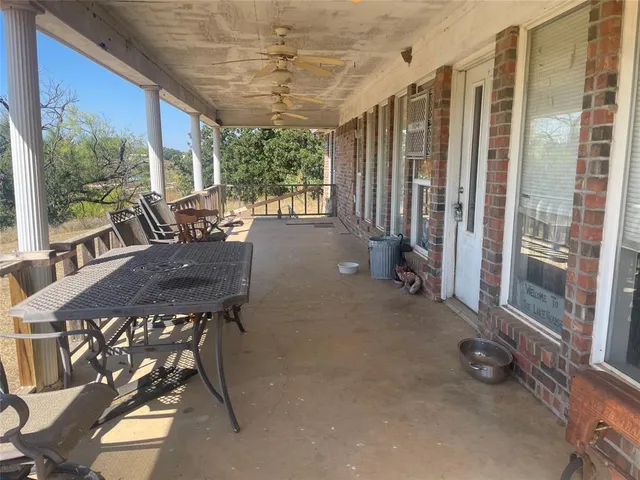 a view of a patio with a table and chairs