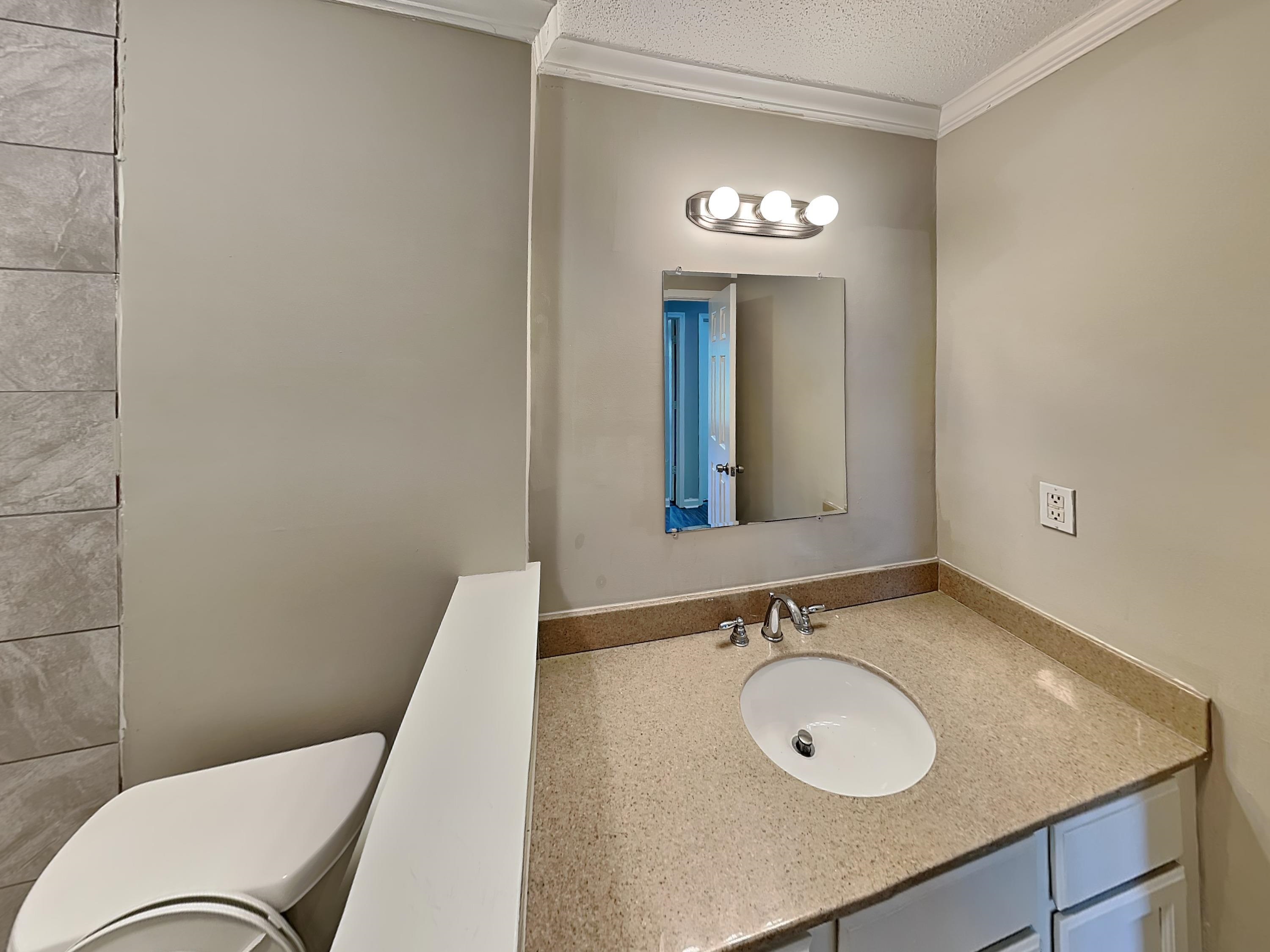 7041 Cutter Mill Road Memphis, TN 38141 - Photo 14 of 18 a bathroom with a sink and a mirror
