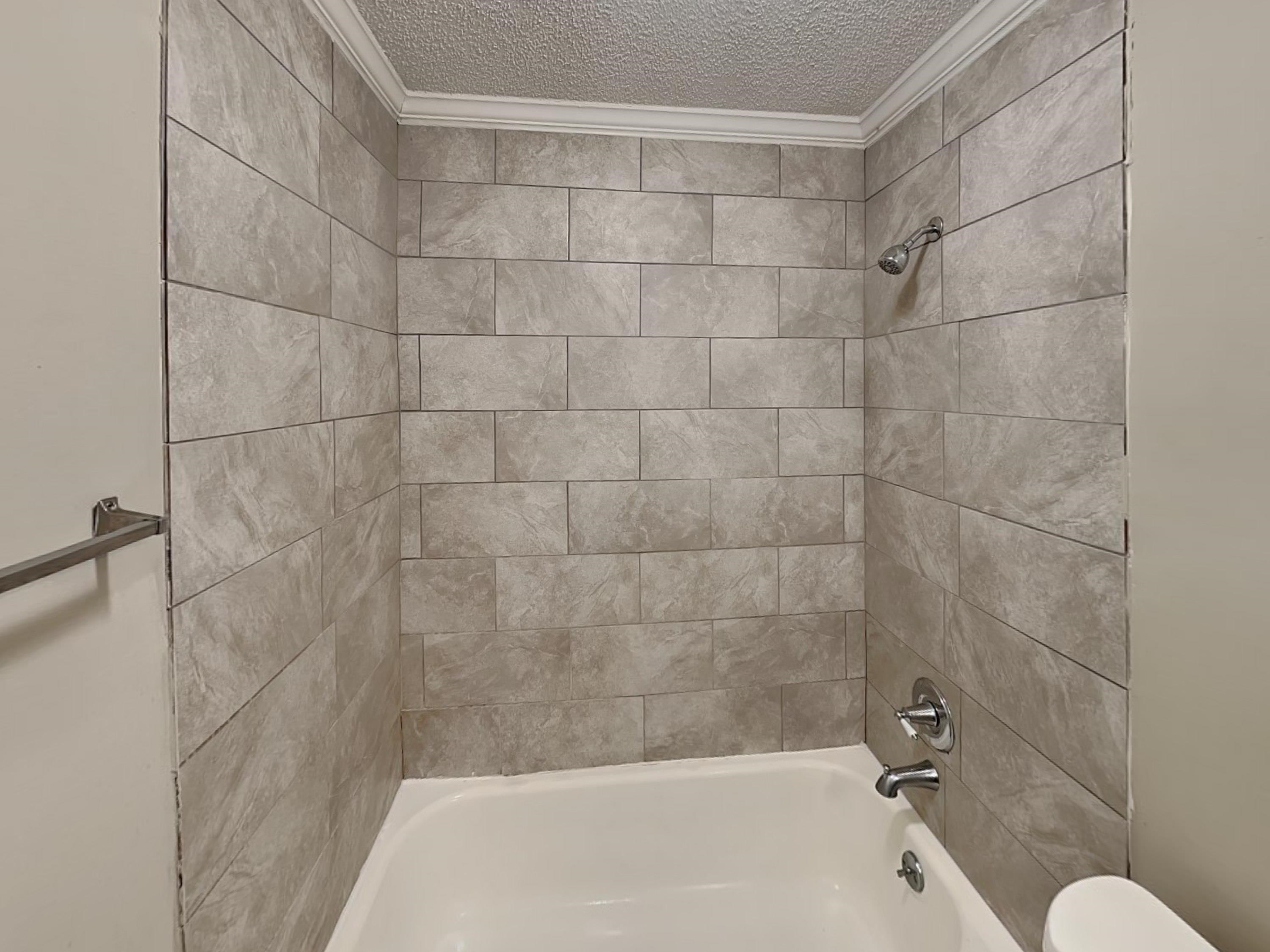 7041 Cutter Mill Road Memphis, TN 38141 - Photo 15 of 18 a bathroom with a bathtub and shower