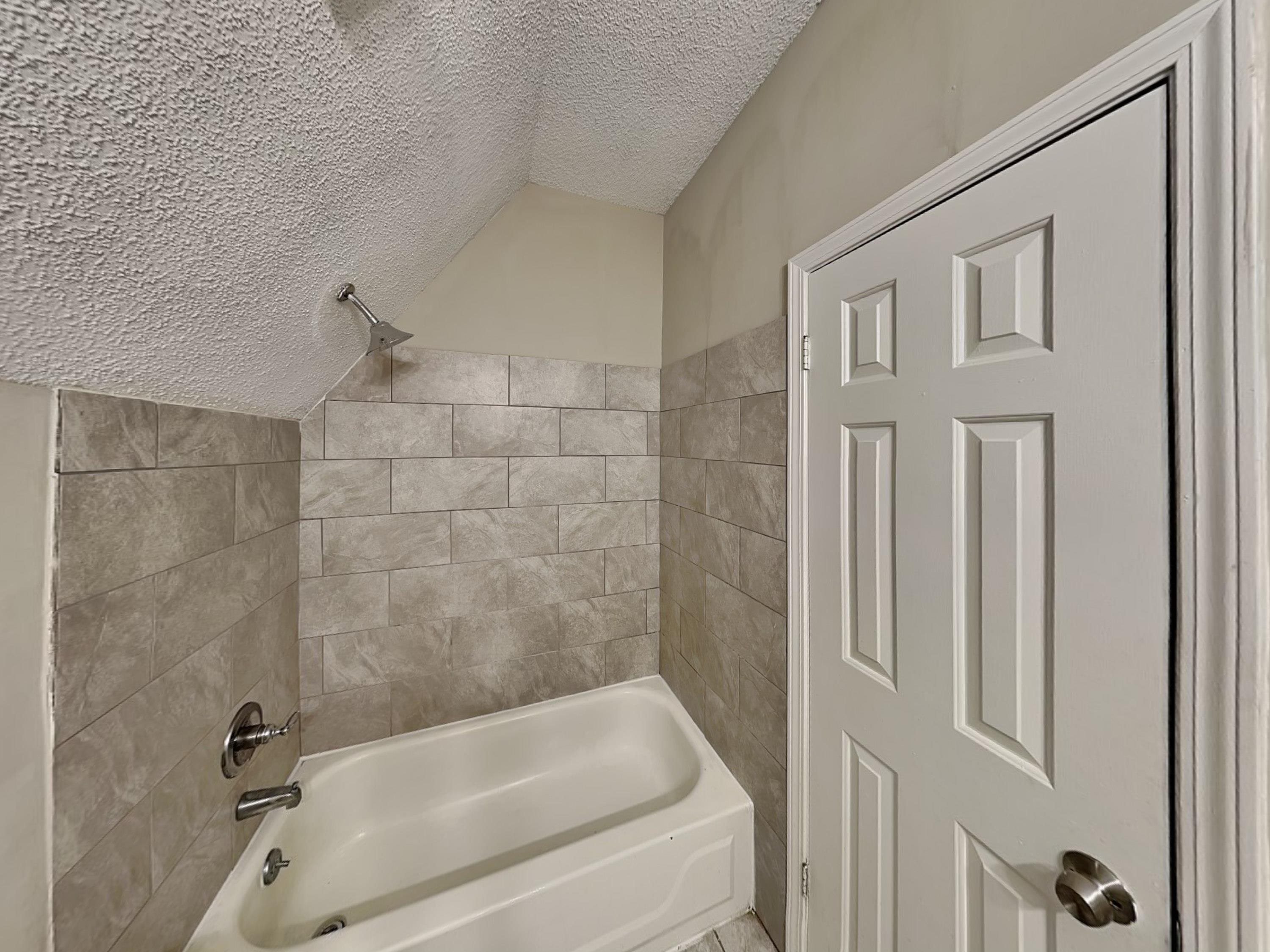 7041 Cutter Mill Road Memphis, TN 38141 - Photo 16 of 18 a bathroom with a bathtub